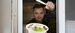 A food truck vendor shows off a meal