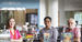 Professors Christina Baker, César Cabezas and Augusto Lorenzino standing in front of books on display in Charles Library for Hispanic Heritage Month