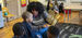 A Temple Jumpstart member reading to preschool children in a classroom at St. Malachy.