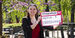 Image of Sydney Binkley holding a sign that reads "media & entertainment."