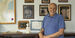 Phil Kendall stands in front of a bookshelf in his office 