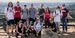 Image of students and faculty posing in front of a fence.