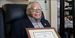 Nelson Henry Jr. holding his honorable discharge certificate.