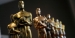 Several Oscar statuettes.