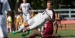 A Temple men's soccer player kicking the ball during a match.