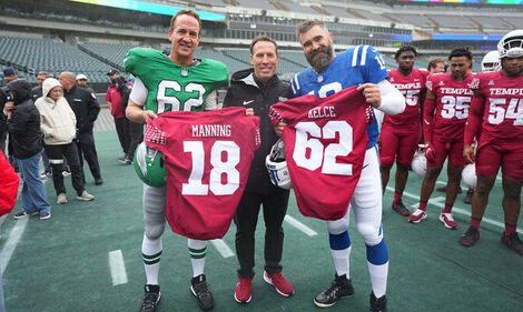Image of Peyton Manning and Jason Kelce with Temple football at Lincoln Financial Field.