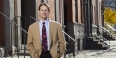 Mark Salzer standing in front of rowhomes.