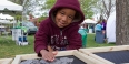 A child plays outside at Temple’s Earth Fest.