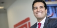 Kevin Negandhi smiling with an ESPN logo in the background.