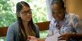 A student receiving guidance from a Temple employee. 