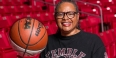 Professor Karen Turner poses with a basketball in the Liacouras Center.