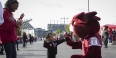 A little girl giving Hooter a high five at a tailgate outside Lincoln Financial Field. 