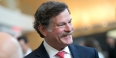 Larry Kaiser smiling as he mingles with guests at medical school event.