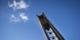 The Bell Tower and a bright blue sky with a few white clouds in the background. 