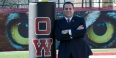 Patrick Kraft leaning against a pole on Temple’s practice football field.