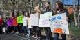 Students holding signs during a walk to raise awareness around sexual assault. 