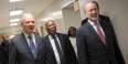 Three men in suits touring the new medical suite at Temple’s dental school. 
