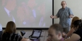 Jim Macmillan talking to students in a classroom. 