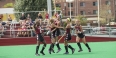 Temple’s field hockey team celebrating on the field. 