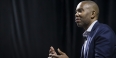 Ta-Nehisi Coates talking with a black curtain behind him. 