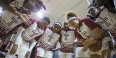 The women’s basketball team having a team huddle.