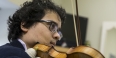 Samuel Nebyu playing the violin. 