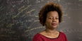 Chelsea Walton standing in front of a blackboard full of math equations
