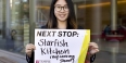 Lei Zhao holding a sign for her next stop, Starfish Kitchen.
