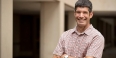 Daniel Berman standing with his arms crossed, smiling.