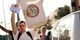 a student holding up his recycling bin