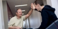 Professor John Nosek demonstrating GAINS on a tablet with a student