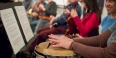 Hands holding a drum with a slit in it