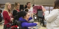 Diana “D” Rich, a student, receiving a customized visor for her communication device.
