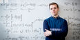Marcus Forst in front of a whiteboard filled with equations