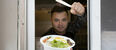 A food truck vendor shows off a meal