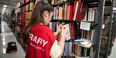 a student labeling books in Paley Library