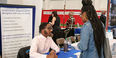 an employer tables at the job fair