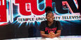A teenage girl sitting at the anchor desk at TUTV