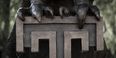 a close up of Main Campus' Owl statue's talons gripping the Temple "T" 