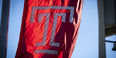 A flag with the Temple logo on campus