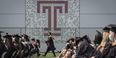 Graduates on the field at Edberg-Olson Athletic Hall during Commencement. 