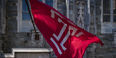 Image of the cherry and white Temple ‘T’ flag outside of Sullivan Hall on Main Campus.