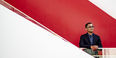 Heath Fogg Davis standing by a staircase with a red background.