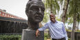 President Jason Wingard stands beside a bust of Temple University founder Russel Conwell.