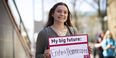 Grace Ratkey holding a sign that says My big future: Ending homelessness