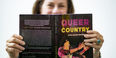 Shana Goldin-Perschbacher holding her book, Queer Country 