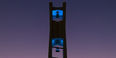 The Bell Tower at night lit up in teal