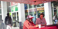 Image of a red canopy tent outside of Maxi’s Pizza, Subs and Bar on campus. 