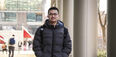 Edmond Tsan walks through campus
