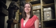 Melissa Krug standing with ancient artifacts in the background. 